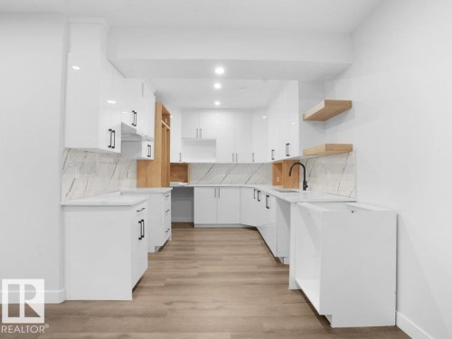 Kitchen featuring white cabinetry, open shelves, light wood-type flooring, and backsplash - 6131 Crawford Drive, Edmonton, AB - Indoor Photo Showing Kitchen