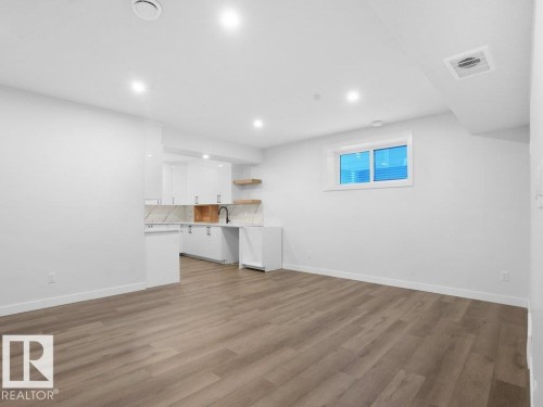 Unfurnished living room featuring light wood-type flooring and recessed lighting - 6131 Crawford Drive, Edmonton, AB - Indoor Photo Showing Other Room