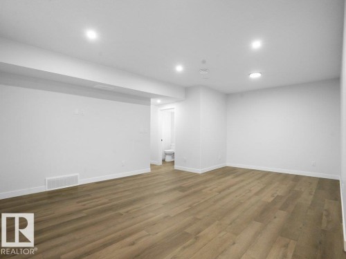 Finished basement featuring recessed lighting and wood finished floors - 6131 Crawford Drive, Edmonton, AB - Indoor Photo Showing Other Room