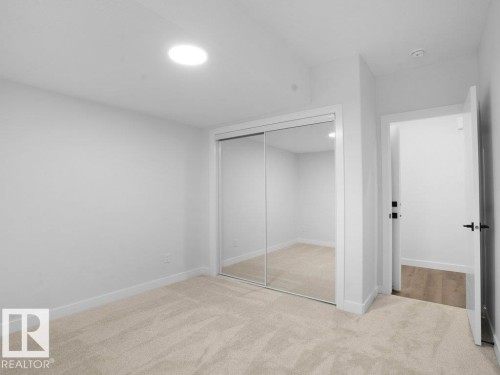 Unfurnished bedroom featuring a closet and light colored carpet - 6131 Crawford Drive, Edmonton, AB - Indoor Photo Showing Other Room