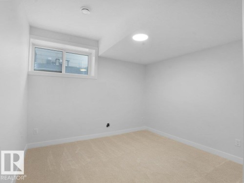 Empty room featuring light colored carpet and baseboards - 6131 Crawford Drive, Edmonton, AB - Indoor Photo Showing Other Room