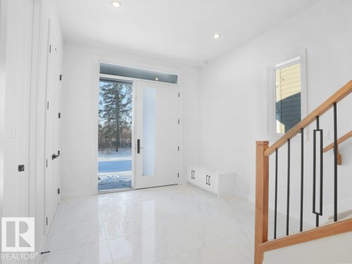 Foyer entrance featuring stairs, light marble finish flooring, and recessed lighting - 6131 Crawford Drive, Edmonton, AB - Indoor Photo Showing Other Room