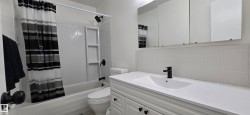 Full bathroom with backsplash, vanity, and shower / tub combo with curtain - 
