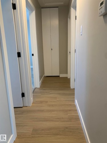 Hallway featuring light wood-style floors and baseboards - 10816 163 Street, Edmonton, AB - Indoor Photo Showing Other Room