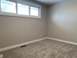 Carpeted spare room featuring baseboards - 