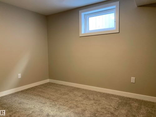 Empty room featuring carpet floors and baseboards - 10816 163 Street, Edmonton, AB - Indoor Photo Showing Other Room