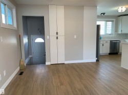 Entrance foyer featuring dark wood-type flooring and baseboards - 
