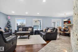 Living area with marble finish floors and recessed lighting - 
