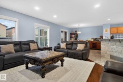 Living area with light wood finished floors and recessed lighting - 