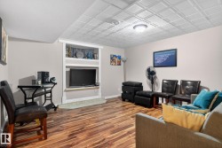 Living room featuring wood finished floors and built in features - 