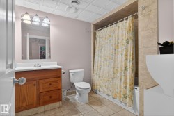 Full bathroom featuring an ornate ceiling, vanity, and shower / tub combo with curtain - 
