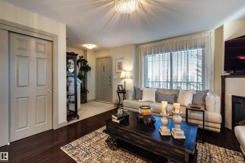 52 1150 Windermere Way, Edmonton, AB - Indoor Photo Showing Living Room With Fireplace