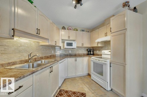 25 603 Youville Drive E, Edmonton, AB - Indoor Photo Showing Kitchen With Double Sink