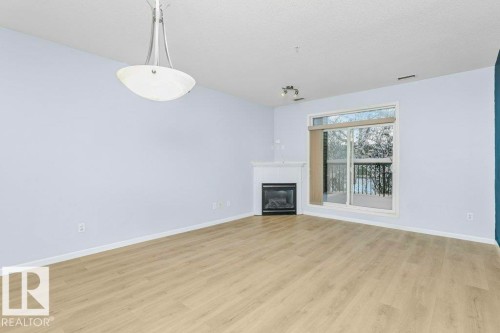 119 2503 Hanna Crescent, Edmonton, AB - Indoor Photo Showing Other Room With Fireplace