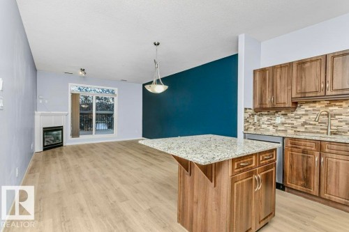 119 2503 Hanna Crescent, Edmonton, AB - Indoor Photo Showing Kitchen With Fireplace