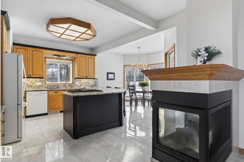 47 Willow Springs Crescent, Sylvan Lake, AB - Indoor Photo Showing Kitchen With Fireplace