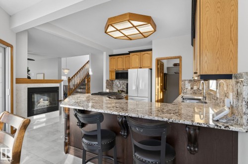 47 Willow Springs Crescent, Sylvan Lake, AB - Indoor Photo Showing Kitchen With Fireplace With Upgraded Kitchen