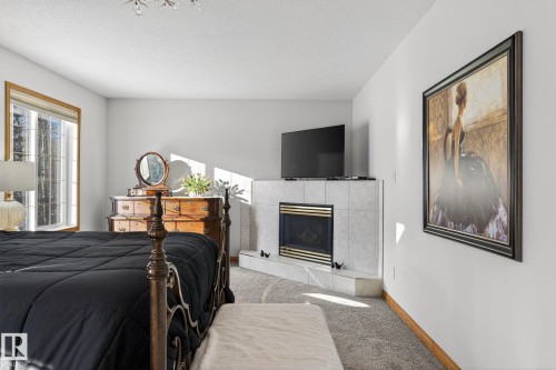 47 Willow Springs Crescent, Sylvan Lake, AB - Indoor Photo Showing Bedroom With Fireplace