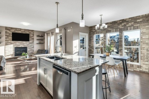 7647 181 Avenue, Edmonton, AB - Indoor Photo Showing Kitchen With Fireplace With Double Sink With Upgraded Kitchen