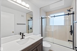 Full bathroom with enclosed tub / shower combo and vanity - 