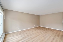 Spare room featuring baseboard heating and light wood-type flooring - 