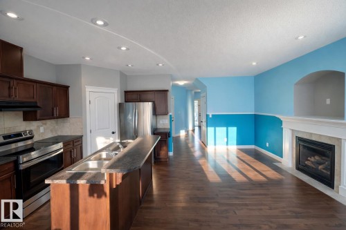 2825 16A Avenue, Edmonton, AB - Indoor Photo Showing Kitchen With Fireplace With Double Sink