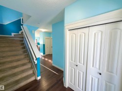 Stairway featuring hardwood / wood-style floors and a textured ceiling - 