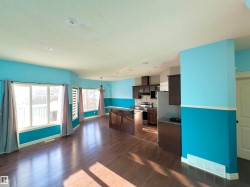 Game room featuring a chandelier, a textured ceiling, and dark wood finished floors - 
