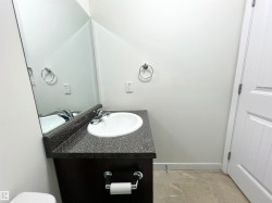 Half bath featuring vanity and baseboards - 