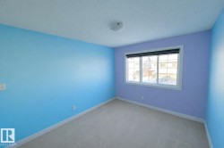 Carpeted spare room with a textured ceiling and baseboards - 