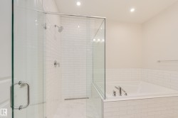 Full bath featuring a bath, a stall shower, and recessed lighting - 