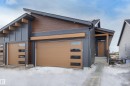 Modern home with roof with shingles, a front lawn, view of scattered trees, a garage, and driveway - 207 Stonehouse Way, Leduc, AB  - Outdoor 