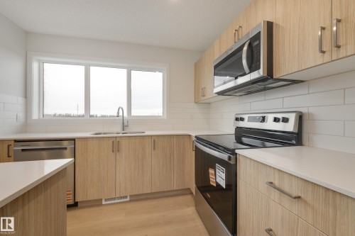 17235 4 Street, Edmonton, AB - Indoor Photo Showing Kitchen With Double Sink