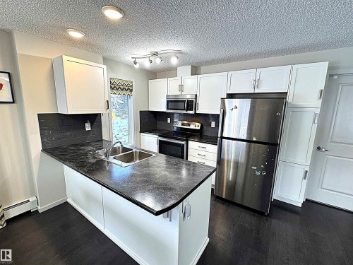 117 5521 7 Avenue, Edmonton, AB - Indoor Photo Showing Kitchen With Stainless Steel Kitchen With Double Sink