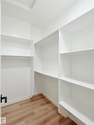 Walk in closet featuring light wood-type flooring - 3320 Chickadee Drive, Edmonton, AB - Indoor With Storage