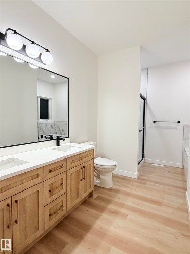 Bathroom featuring double vanity, a tub to relax in, a shower stall, and light wood finished floors - 3320 Chickadee Drive, Edmonton, AB - Indoor Photo Showing Bathroom