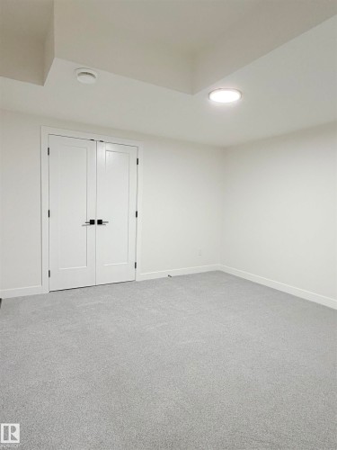 Unfurnished bedroom with light colored carpet and a closet - 3320 Chickadee Drive, Edmonton, AB - Indoor Photo Showing Other Room