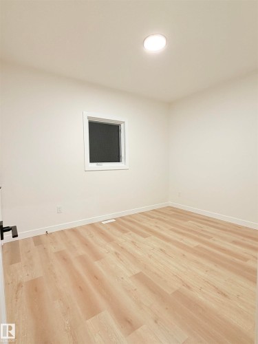 Unfurnished room featuring light wood finished floors and baseboards - 3320 Chickadee Drive, Edmonton, AB - Indoor Photo Showing Other Room