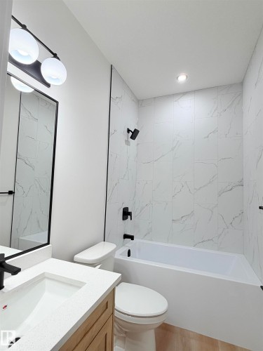 Bathroom featuring vanity and shower / washtub combination - 3320 Chickadee Drive, Edmonton, AB - Indoor Photo Showing Bathroom
