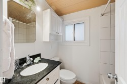 Bathroom with vanity, wooden ceiling, and bathing tub / shower combination - 