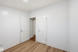 Unfurnished bedroom with light wood-style floors and baseboards - 