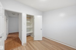 Unfurnished bedroom with light wood-type flooring and a spacious closet - 