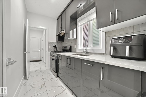 15023 15 Street, Edmonton, AB - Indoor Photo Showing Kitchen With Double Sink