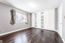Spare room with a textured ceiling and dark wood finished floors - 