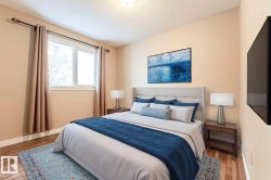 Bedroom featuring a textured ceiling and wood finished floors - 