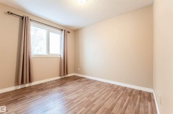 Empty room featuring light wood-style flooring and a textured ceiling - 
