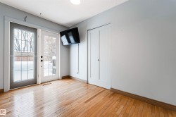 Doorway featuring hardwood / wood-style flooring and baseboards - 