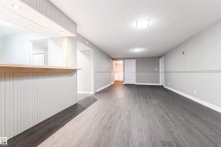 Unfurnished living room with wood finished floors and a textured ceiling - 