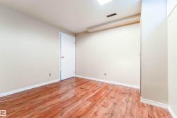 Spare room featuring light wood-type flooring and baseboards - 