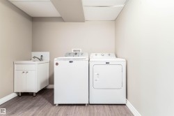 Washroom featuring light wood-style flooring and washer and dryer - 